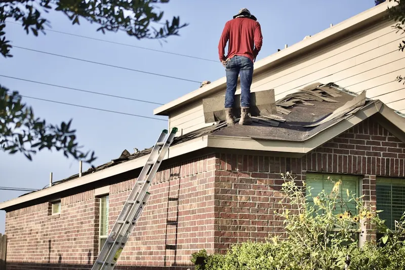 Professional roofer working on a residential roof in Bloomburg Village